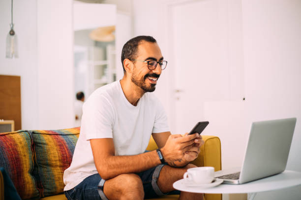 istock Man using smartphone in living room 1279391692
