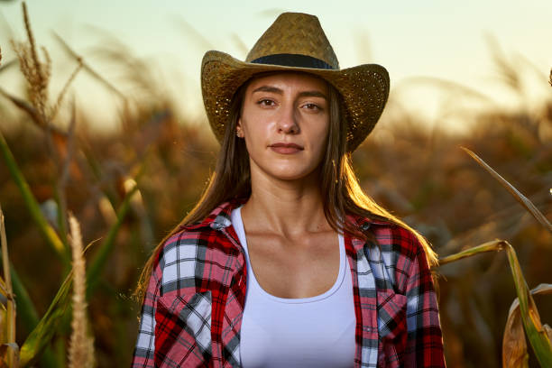 istock Cowgirl standing in a corn field 1279391703