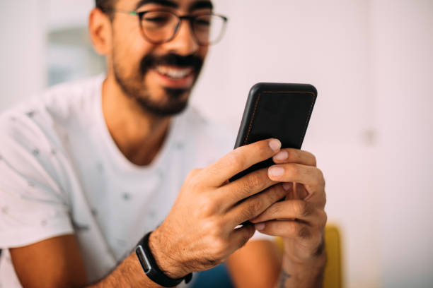 istock Man using smartphone in living room 1279391854
