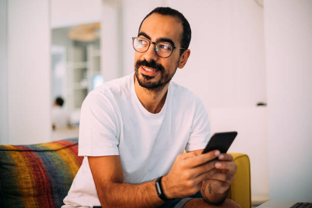 istock Man using smartphone in living room 1279391872
