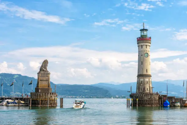 Harbor entrance at Lake Constance, Lindau, Germany. Beautiful landscape with lion statue and lighthouse. Scenic view of Constance or Bodensee in summer. Town of Lindau is tourist attraction of Bavaria