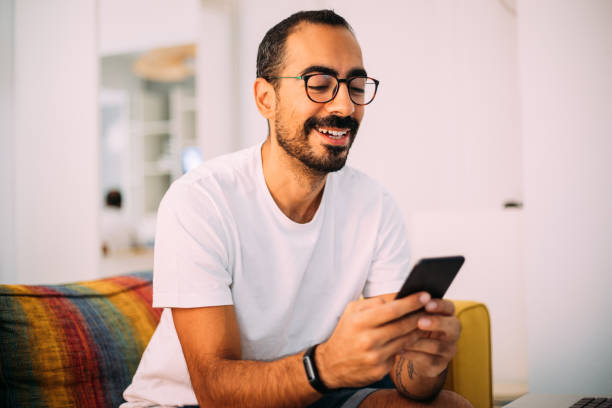istock Man using smartphone in living room 1279391952