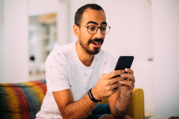 istock Man using smartphone in living room 1279391957