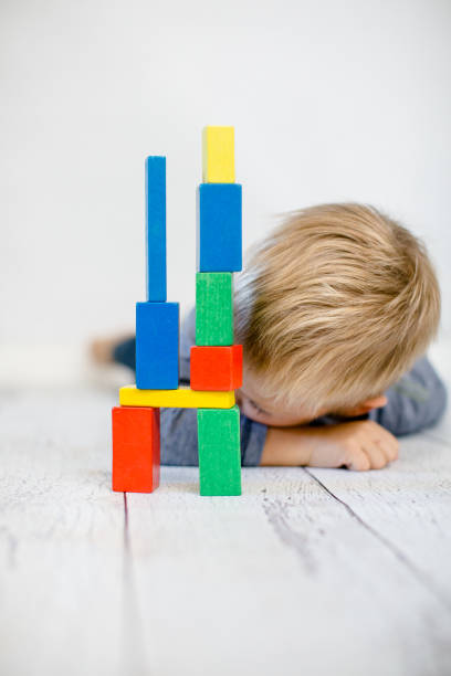 istock child lies with his head on the floor next t 1279392807