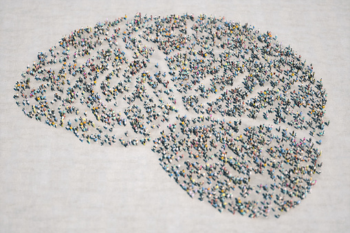 3d low poly people gathered together and formed a brain shape.