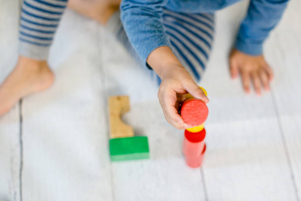 istock Child is sitting on the floor and is playing at home 1279392817