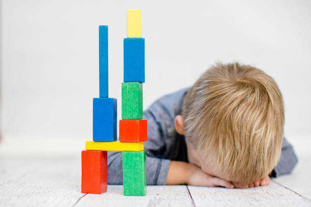 istock child lies with his head on the floor 1279392908
