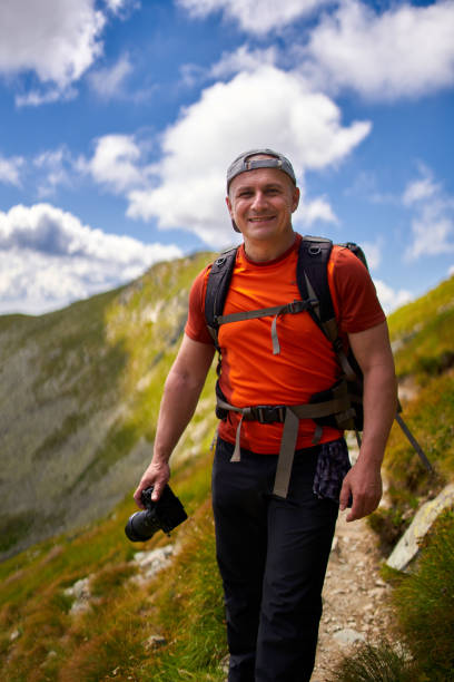 istock Nature photographer with camera in the mountains 1279394110