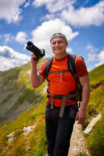 istock Nature photographer with camera in the mountains 1279394115