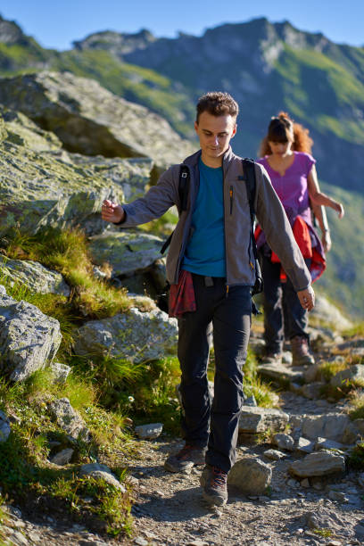 istock Hikers with backpacks in the mountains 1279395308