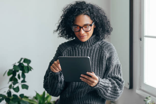 istock Working from Home: a Young Woman USing a Digital Tablet to Read/Watch Something 1279395368