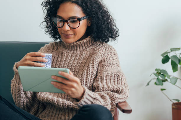 istock Working from Home: a Young Woman USing a Digital Tablet to Read/Watch Something 1279395372