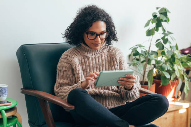 istock Working from Home: a Young Woman USing a Digital Tablet to Read/Watch Something 1279395379