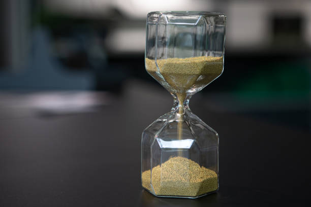 istock on a table stand an egg timer made of glass, which is filled with small balls and runs straight through 1279396272