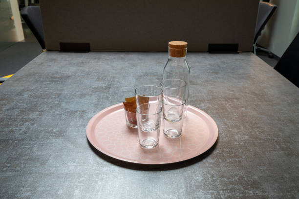istock some glasses and a glass bottle on a tray 1279396287