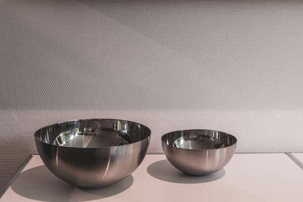 istock 2 different sized metal bowls stand side by side on a white board 1279396299