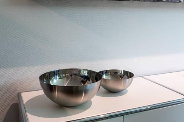 istock 2 different sized metal bowls stand side by side on a white board 1279396301