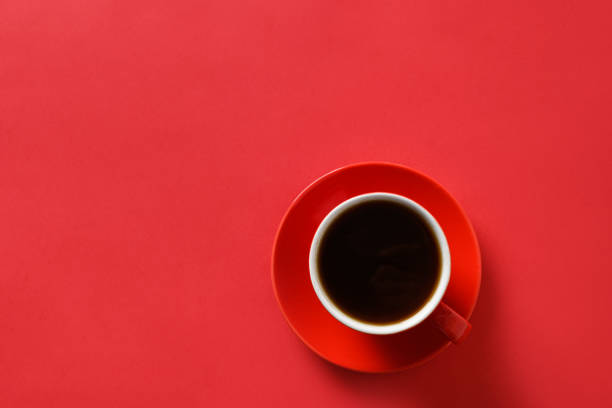 istock Red cup of coffee on red background. Copy space 1279397636
