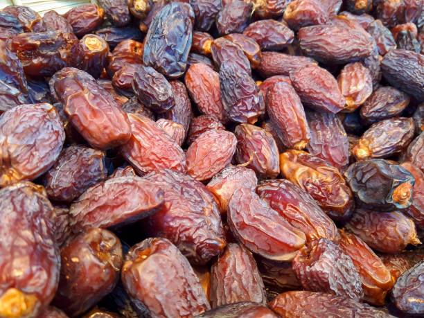 istock Close up of dried dates palm fruit as background 1279400232