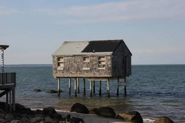 House on stilts in water in Hampton Bays.