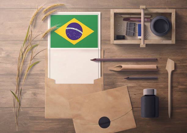 istock Brazil invitation, celebration letter concept. Flag with craft paper and envelope. Retro theme with divide, ink, wooden pen objects. 1279416064