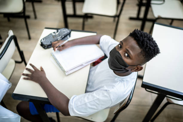 Portrait of a schoolboy studying in the classroom