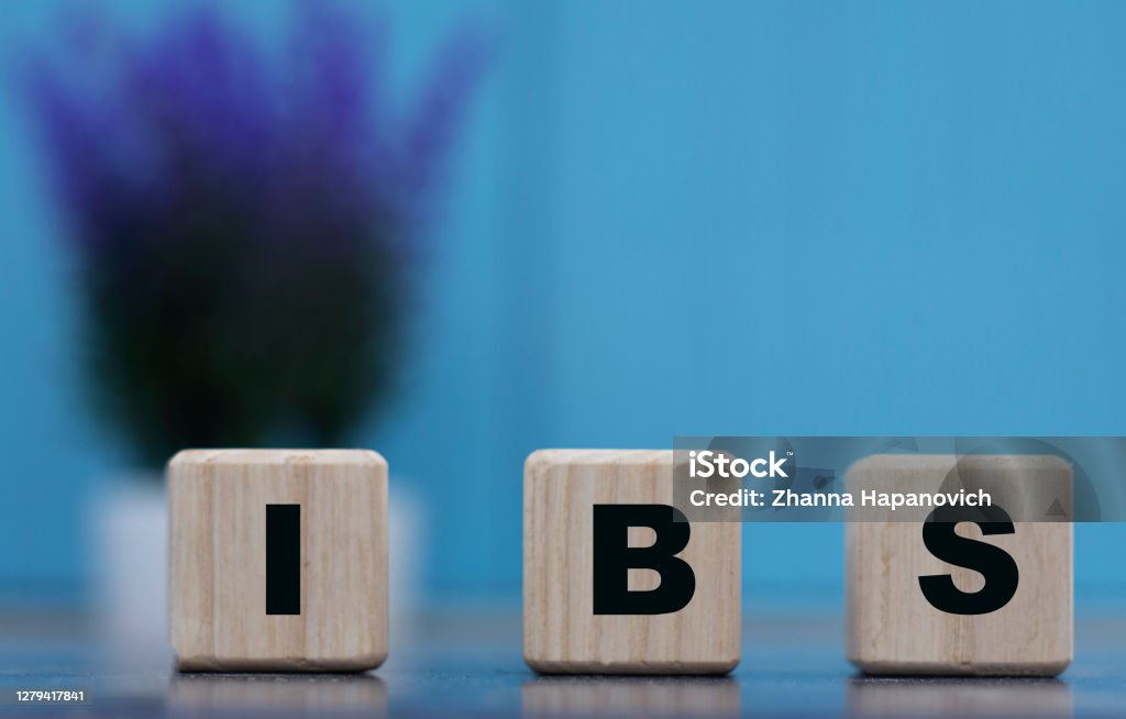 IBS - word on cubes on a blue background with lavender Irritable Bowel Syndrome Stock Photo