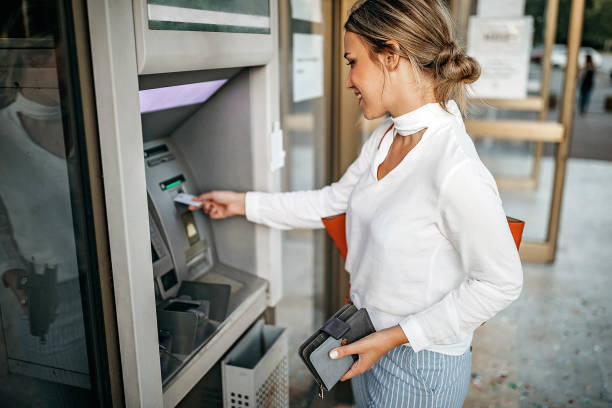 My online wallet Women using ATM machine to withdraw money atm photos stock pictures, royalty-free photos & images