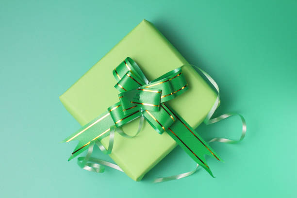 istock Holiday gift concept in colorful packaging on a green background, flat lay. 1279422187
