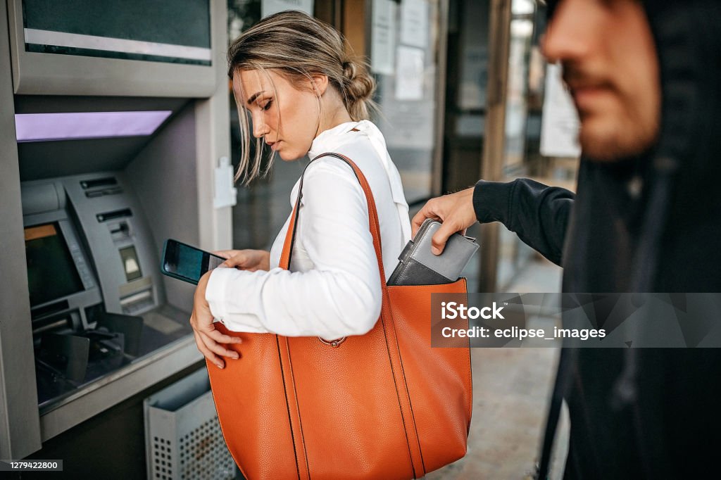 You are not safe Man stealing money and personal stuff from woman Stealing - Crime Stock Photo