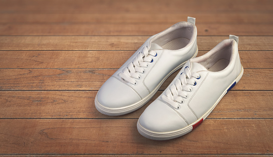White casual shoes on wooden background