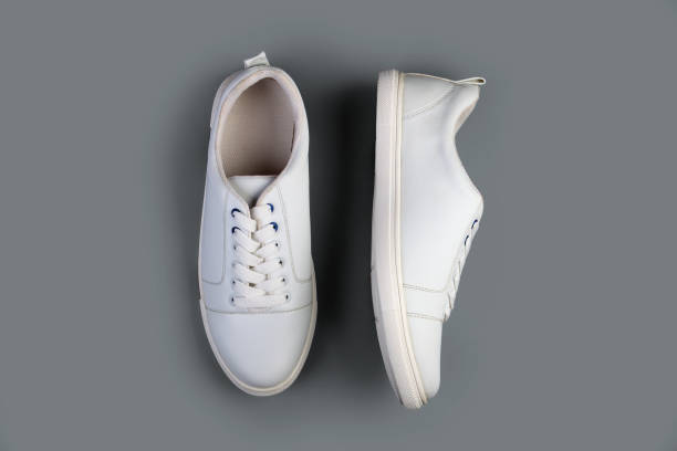 istock White casual shoes on gray background 1279429199