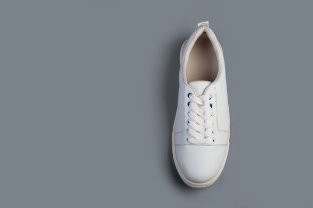istock White casual shoes on gray background 1279429229