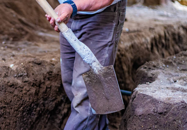 istock Hand holding shovel in dirt 1279431735