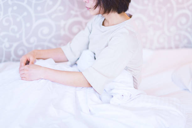 istock middle aged woman get up early on the bed 1279433123
