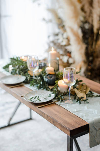 istock Halloween Table setting on dark background. Dish on a dark table with black and gold pumpkin. 1279434128