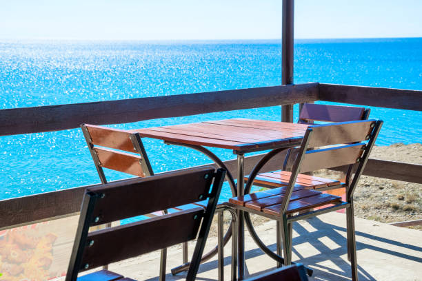 istock Table and chairs by the sea 1279436525