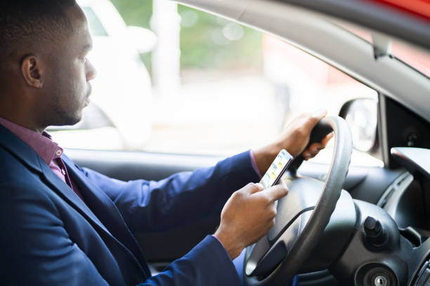 istock Distracted African Man Texting On Mobile Phone 1279444347