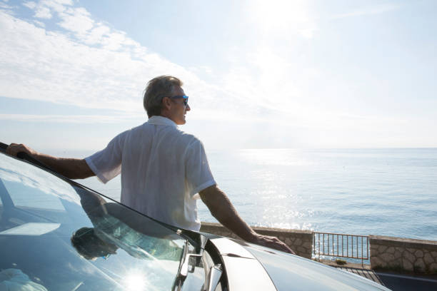 istock Mature man relaxes beside car door 1279444670
