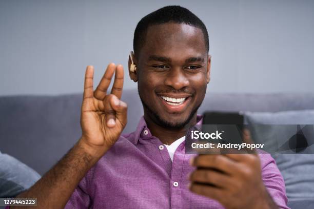 Deaf African Man With Disabilities Stock Photo - Download Image Now - Deafness, Persons with Disabilities, Mobile Phone