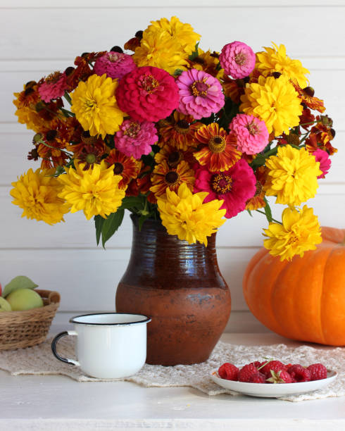 istock autumn light still life with flowers and fruit. 1279447468