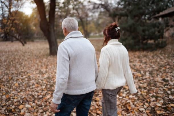 istock Active seniors on a walk in autumn park 1279448154