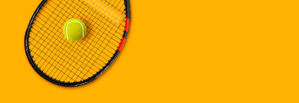 istock Tennis racket ball on yellow background 1279448159