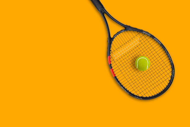 istock Tennis racket ball on yellow background 1279448171