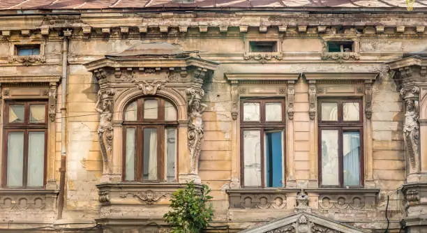 Photo of Detail with an old worn out building. Old vintage architecture in Bucharest, Romania.