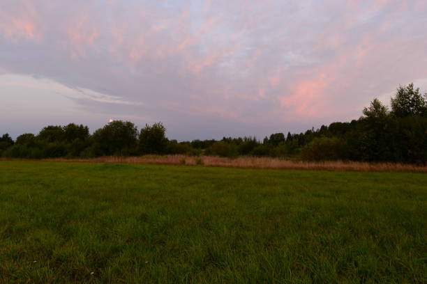 istock Dawn sky over a freshly cut green field in early autumn 1279448455