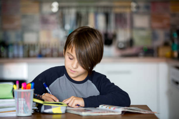 istock Child, writing homework, kid learning at home during pandemic Covid 19 lockdown 1279448565