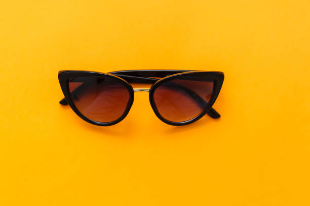 istock Yellow sun glasses isolated over the yellow background 1279449163