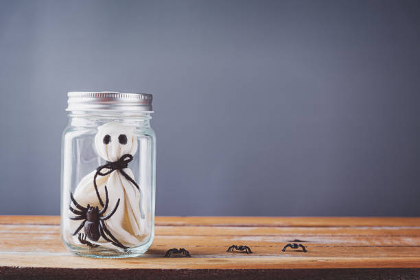 istock closeup white ghost and spider in jar on wooden 1279449225