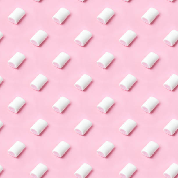 istock Seamless pattern white-pink marshmallows placing on pink flatlay. Marshmallow pastel colors on pink background. 1279449321